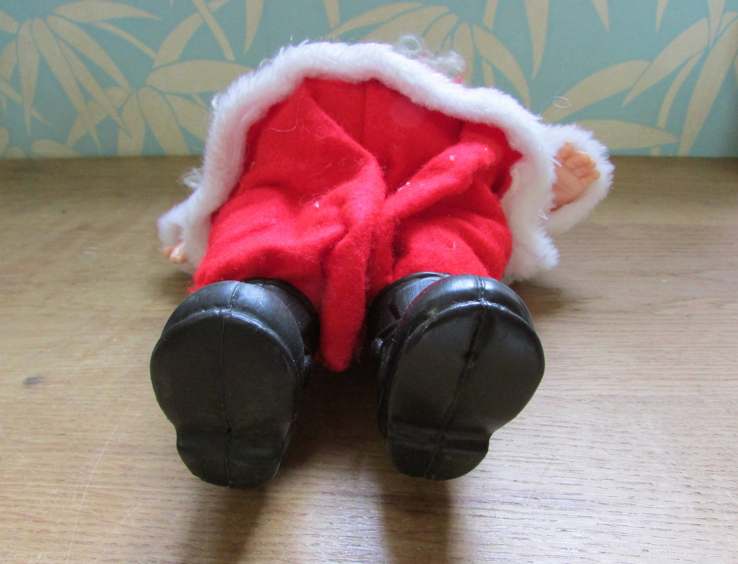circa. 1980s hard plastic Santa Claus doll with wire spectacles