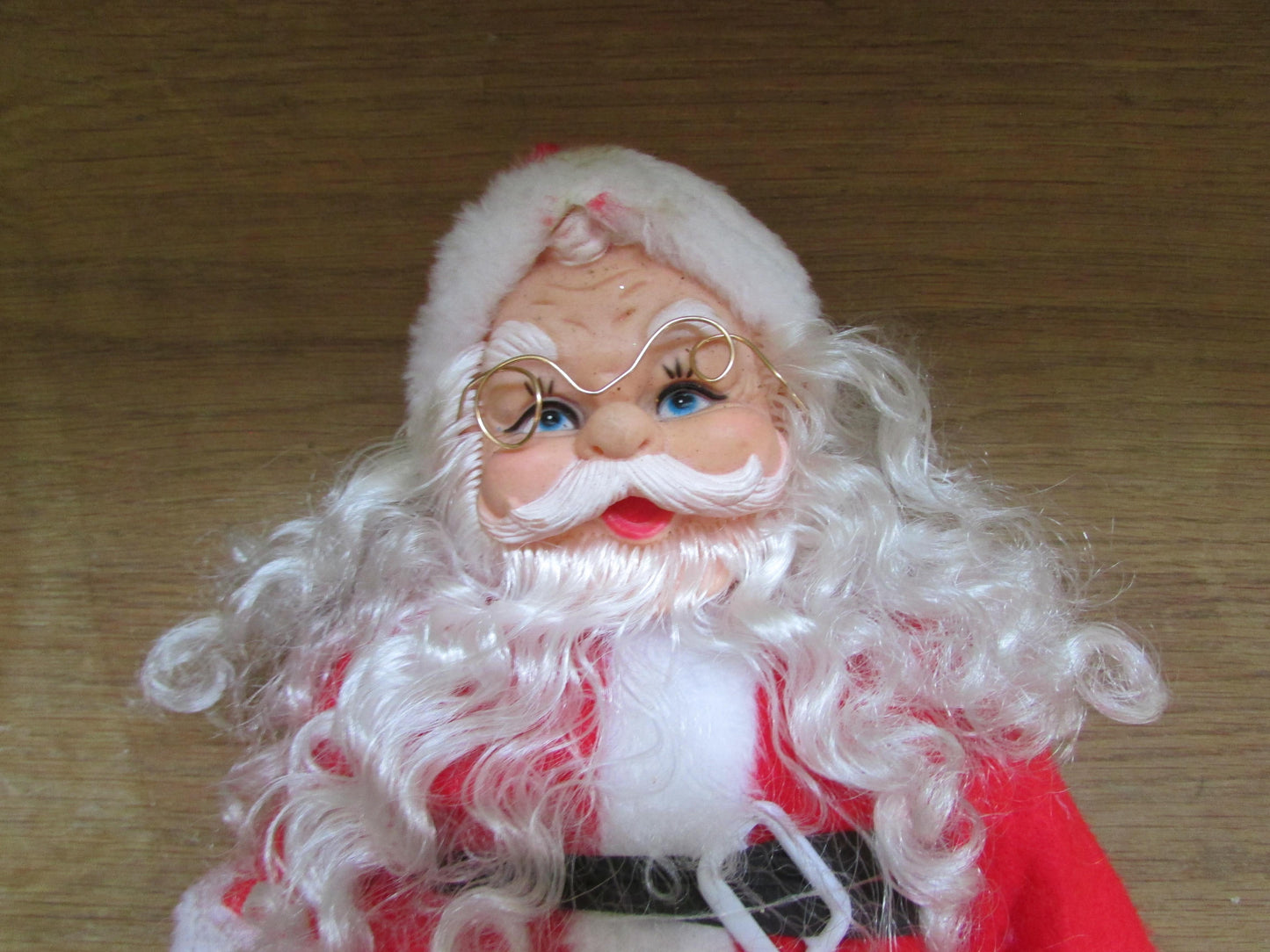 circa. 1980s hard plastic Santa Claus doll with wire spectacles