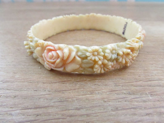 Art Deco carved floral resin/celluloid bangle, stamped Foreign