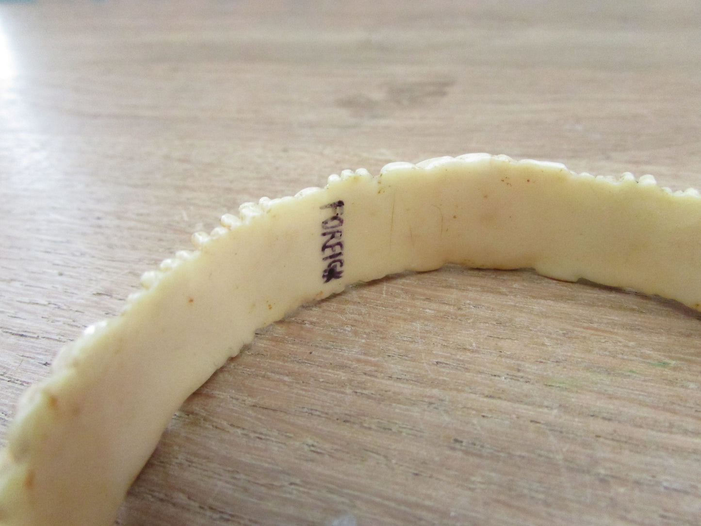 Art Deco carved floral resin/celluloid bangle, stamped Foreign