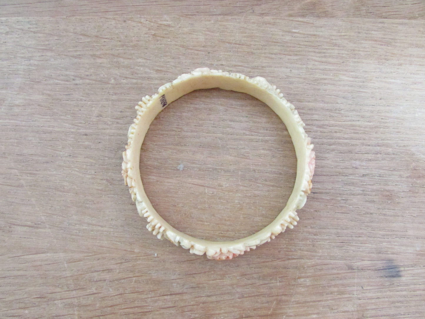 Art Deco carved floral resin/celluloid bangle, stamped Foreign
