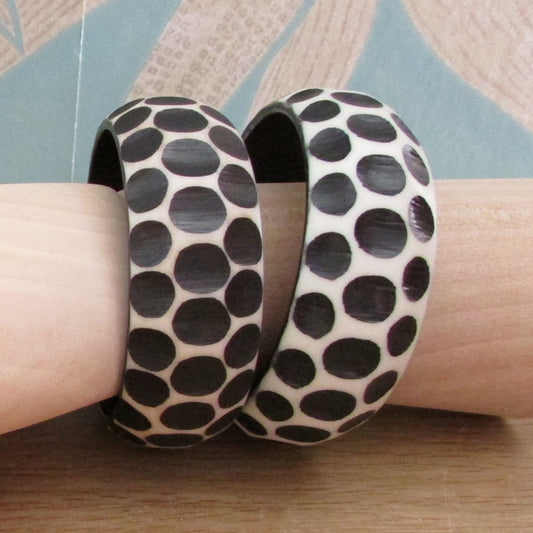 Pair of 1960s carved resin monochrome polka dot bangles