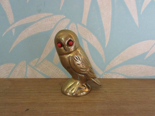 Vintage brass owl ornament with coral-coloured glass eyes
