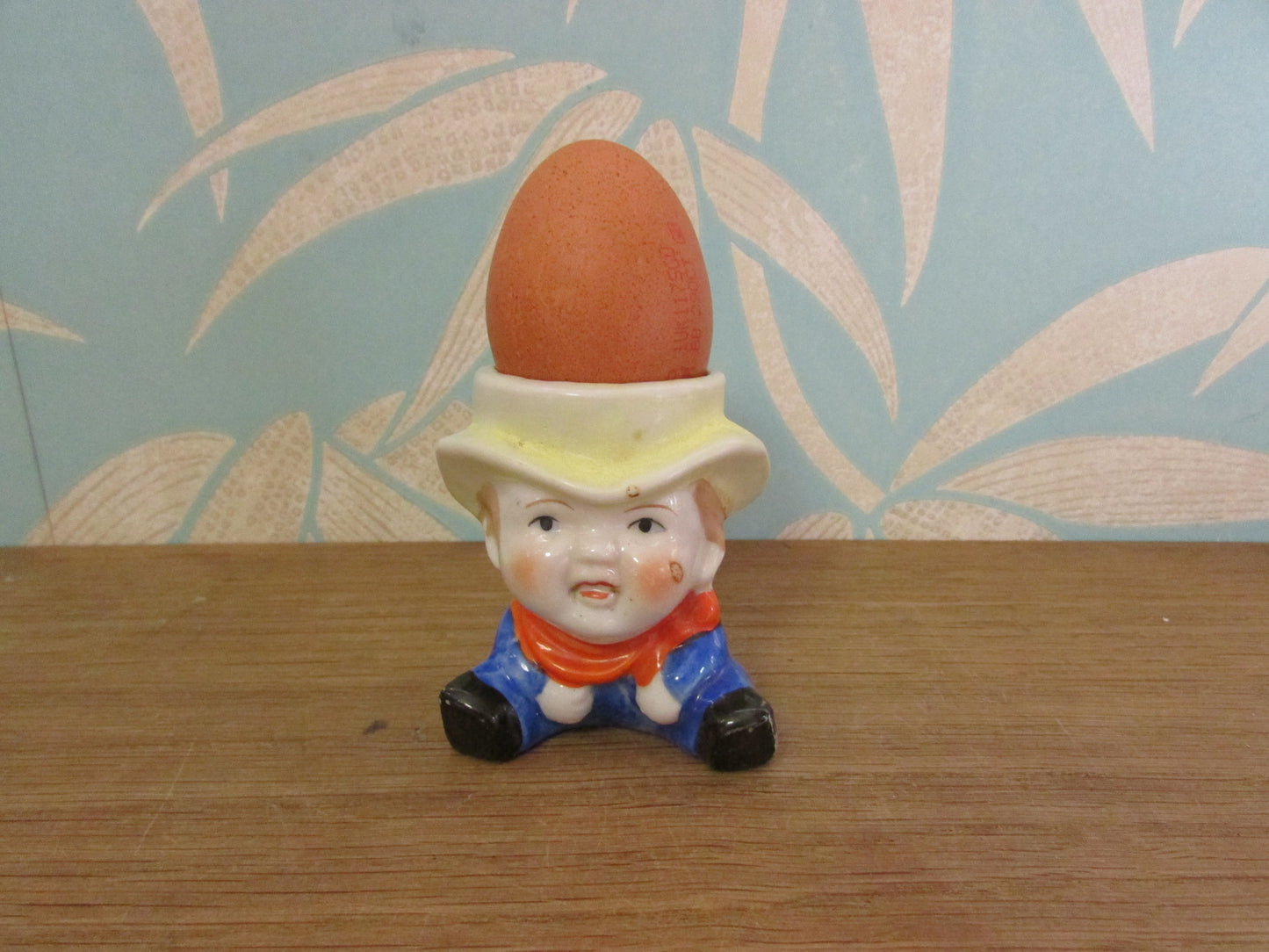 Vintage boy in yellow hat ceramic egg cup
