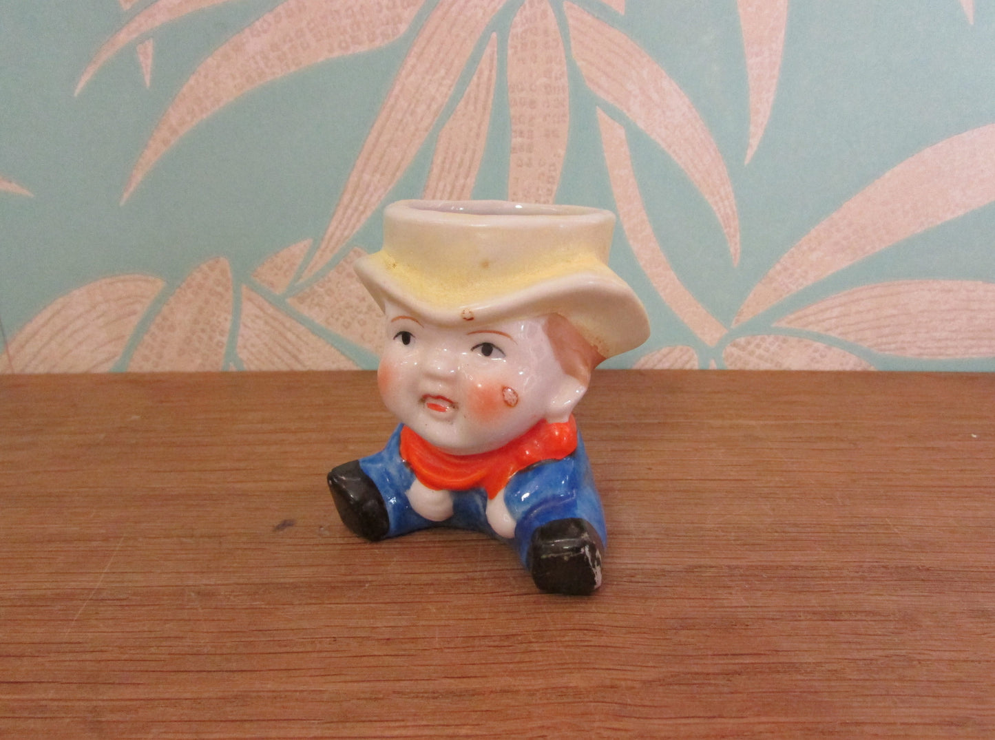 Vintage boy in yellow hat ceramic egg cup