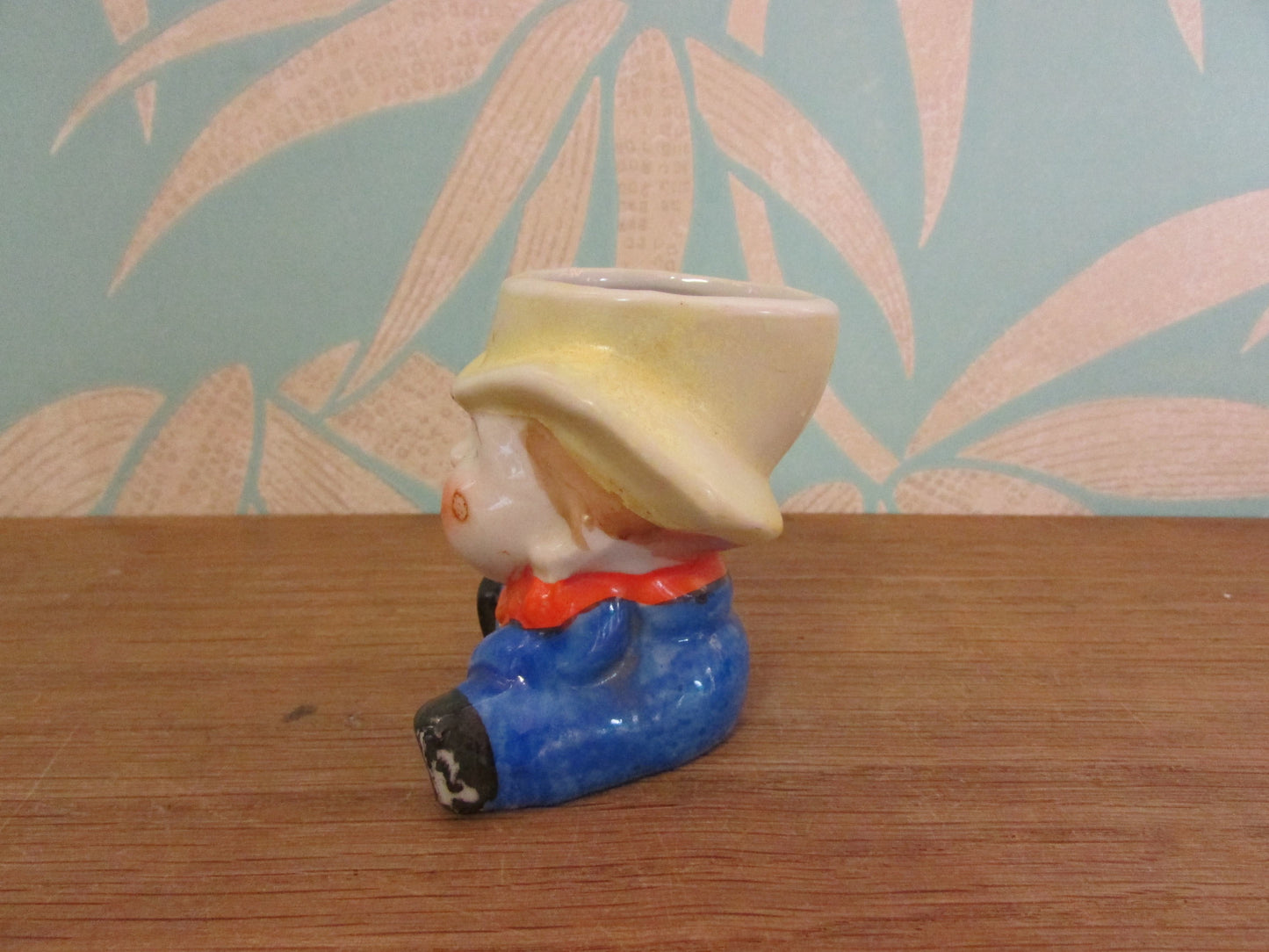 Vintage boy in yellow hat ceramic egg cup