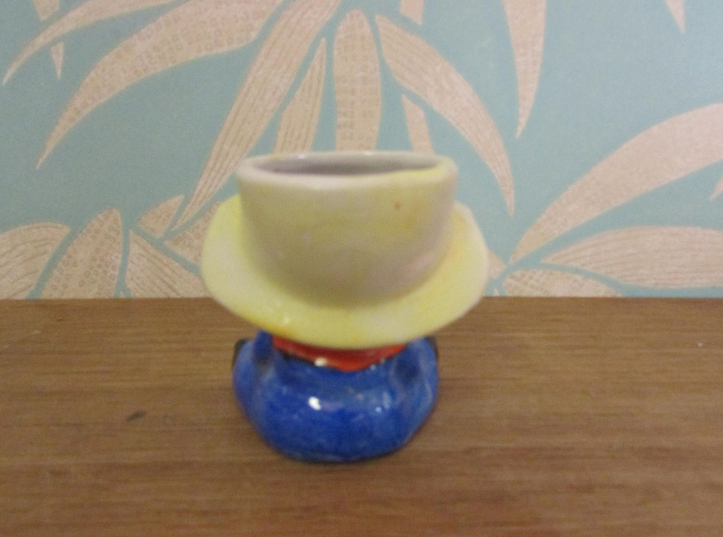 Vintage boy in yellow hat ceramic egg cup
