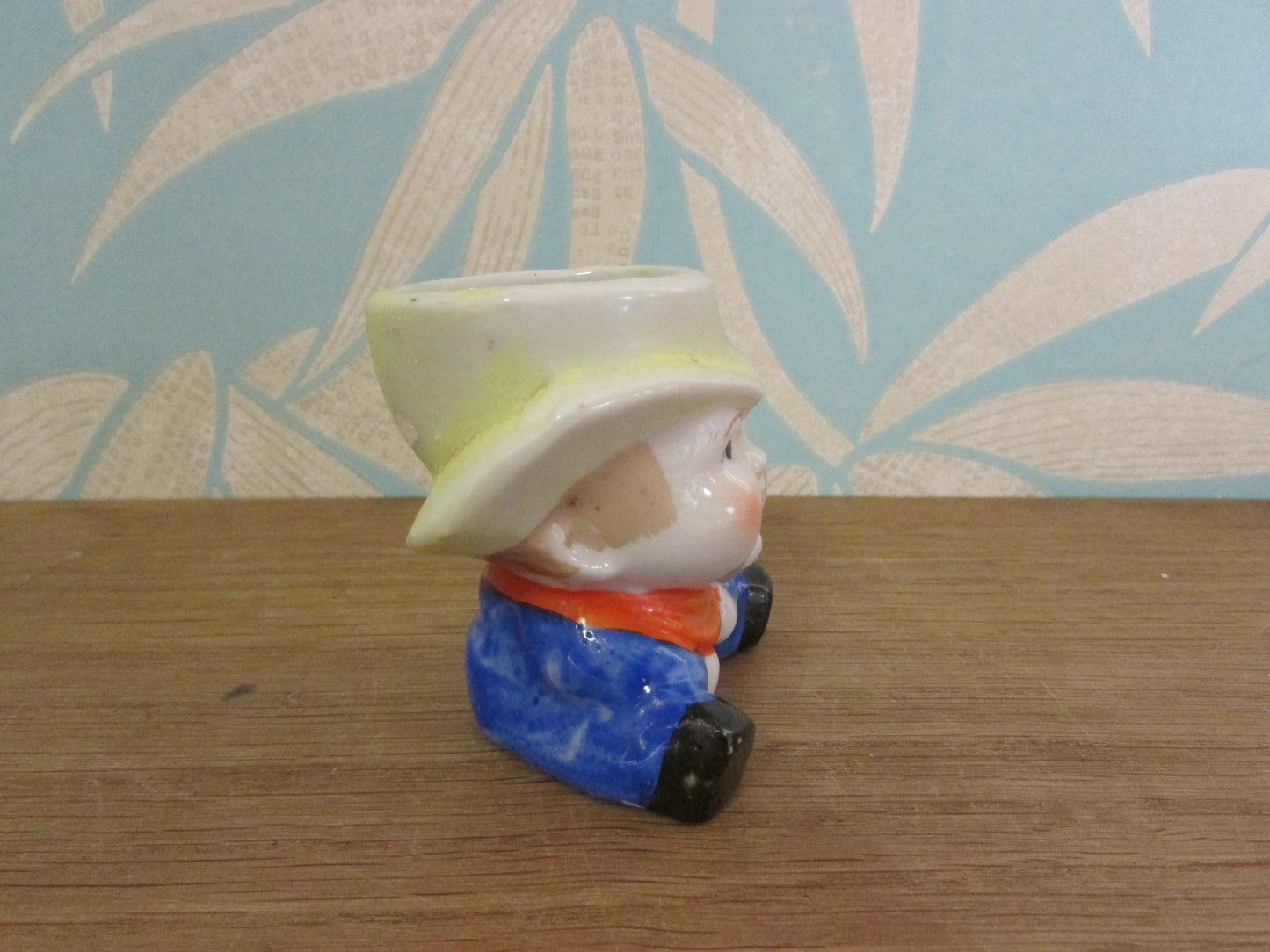 Vintage boy in yellow hat ceramic egg cup