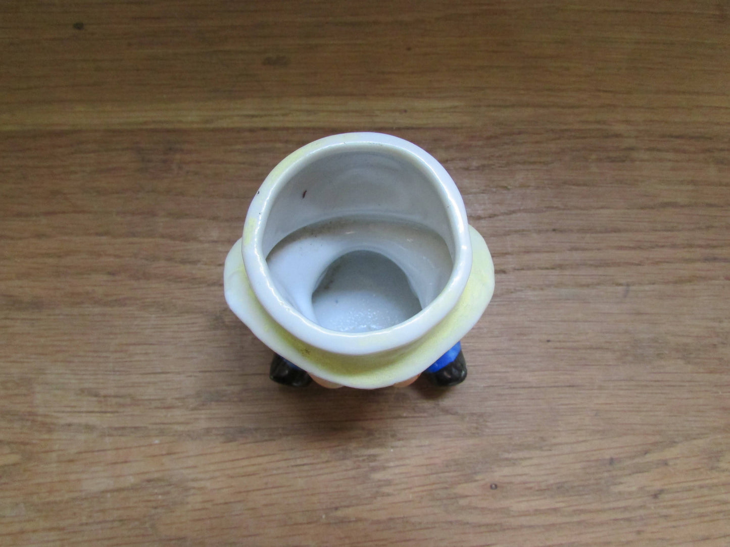 Vintage boy in yellow hat ceramic egg cup