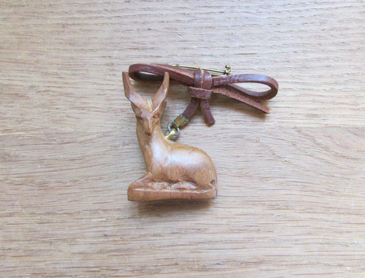 Vintage hand carved wooden sitting antelope brooch with leather bow