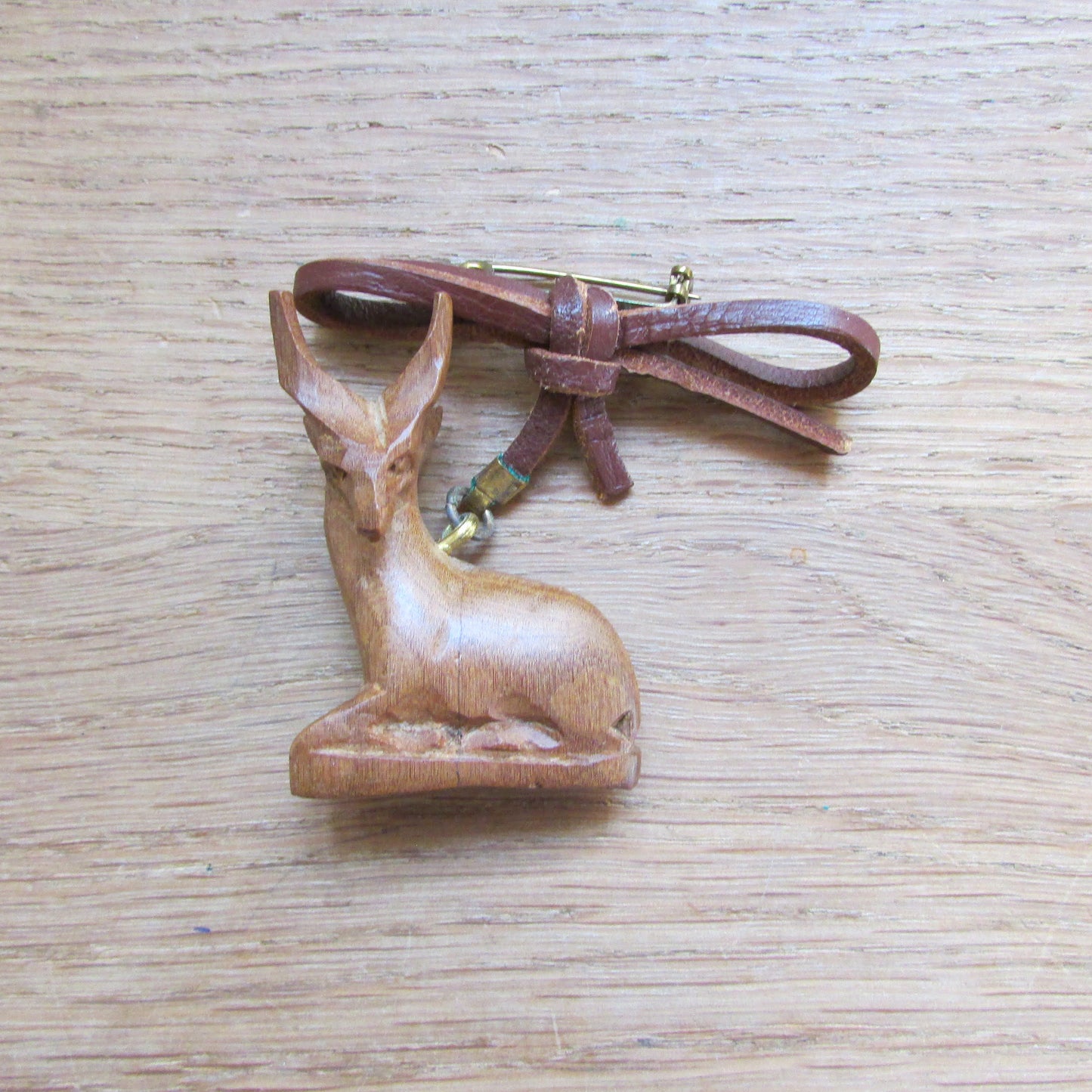 1960s/70s hand carved wooden sitting antelope brooch with leather bow