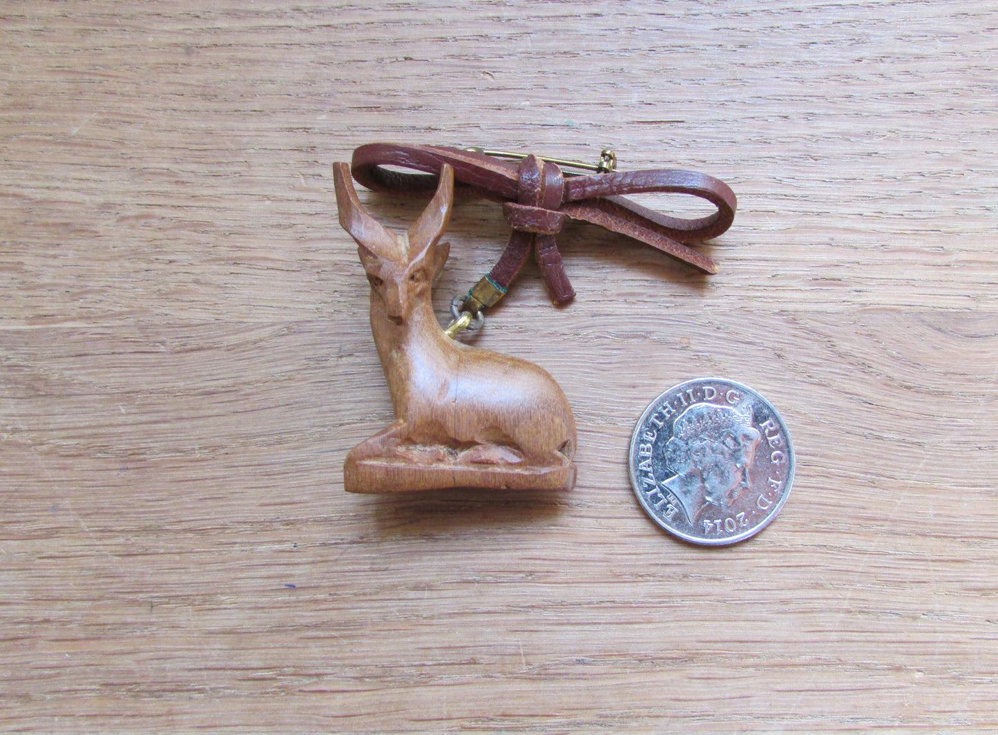 Vintage hand carved wooden sitting antelope brooch with leather bow