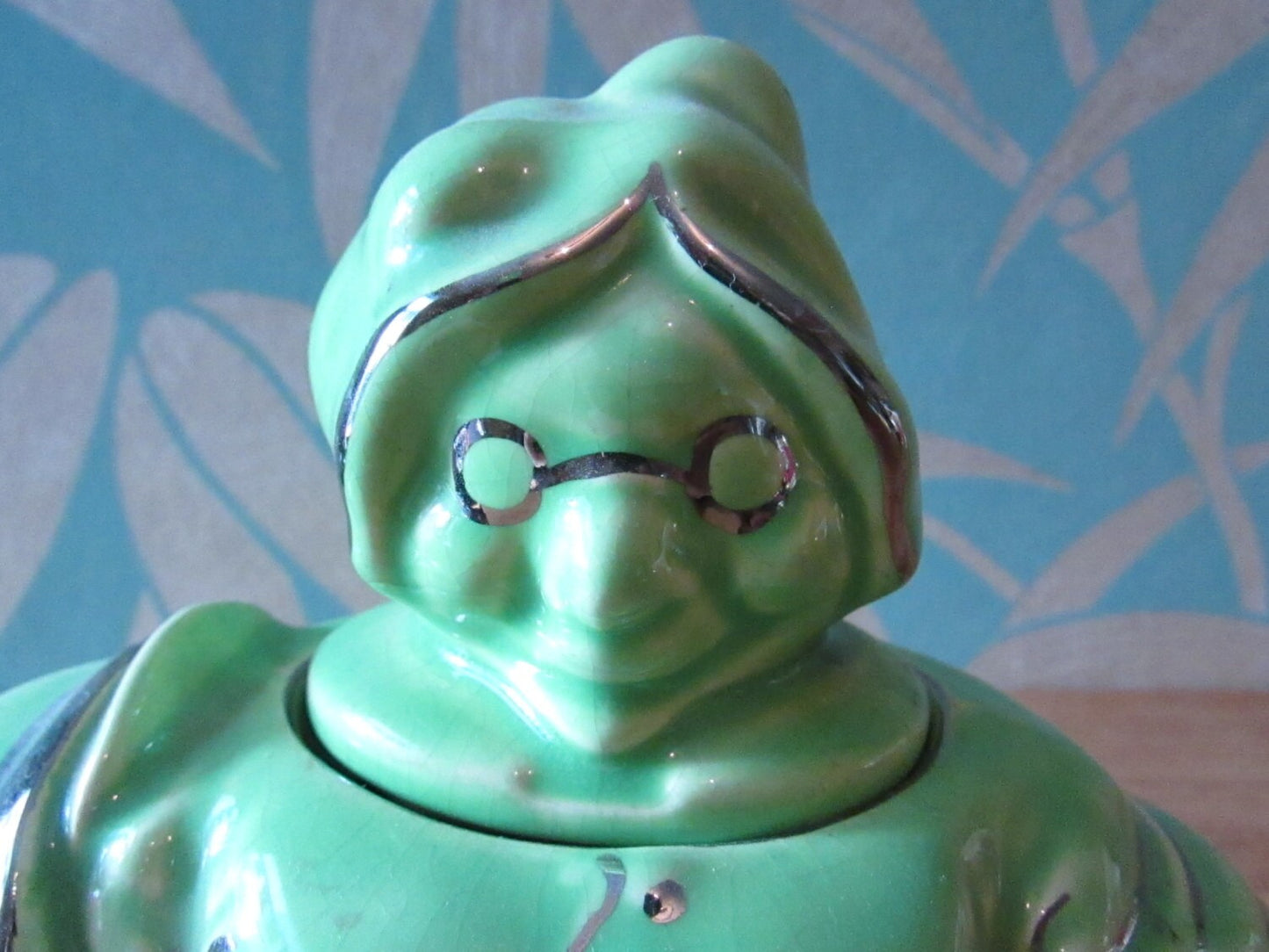 1930s Lingard "Old woman who lived in a shoe" novelty green teapot, silver-finish highlights