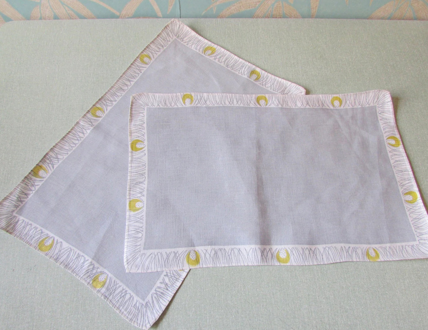 Pair of 1950s linen-like placemats, patterned border