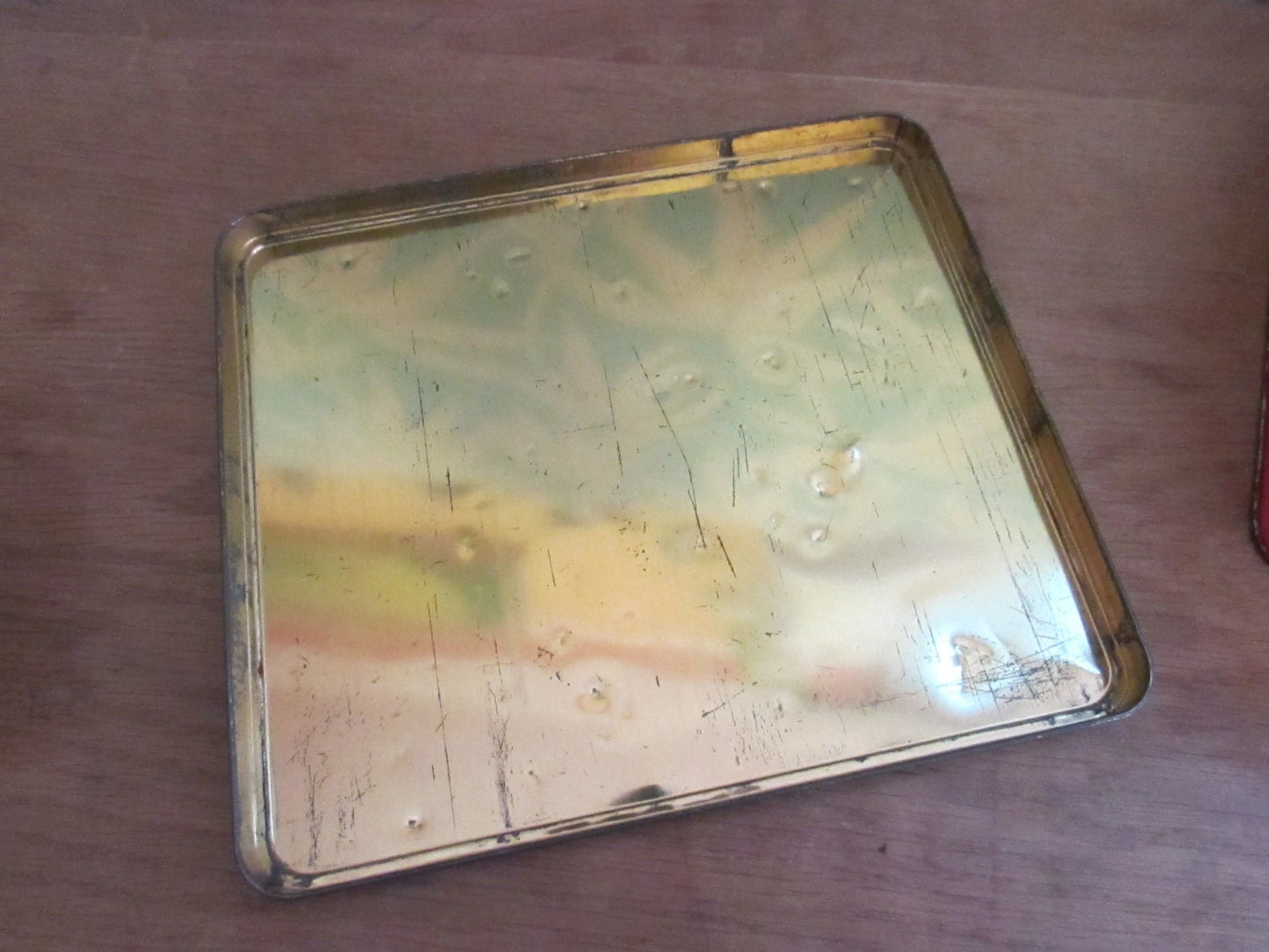 Fun collectable 1960s/70s yellow & orange floral patterned tin, kitsch couple on lid watering sunflowers