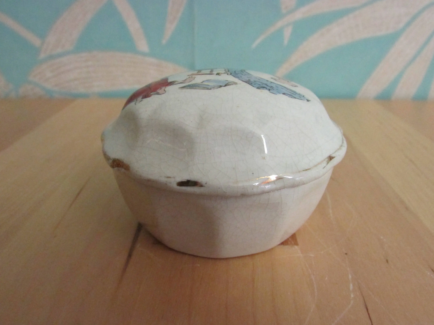 Vintage gilt edged porcelain powder jar with nursery scene transfer detail