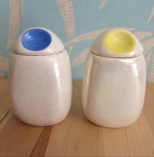 Three mid-century Romanian lustred ceramic storage caddies with contrast colour 'pinched' lids