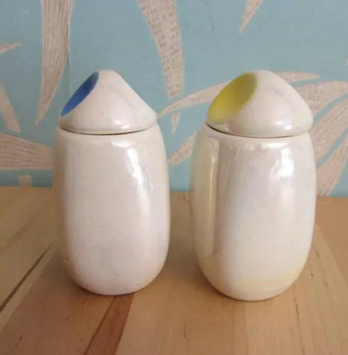 Three mid-century Romanian lustred ceramic storage caddies with contrast colour 'pinched' lids