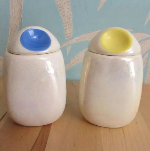 Three mid-century Romanian lustred ceramic storage caddies with contrast colour 'pinched' lids