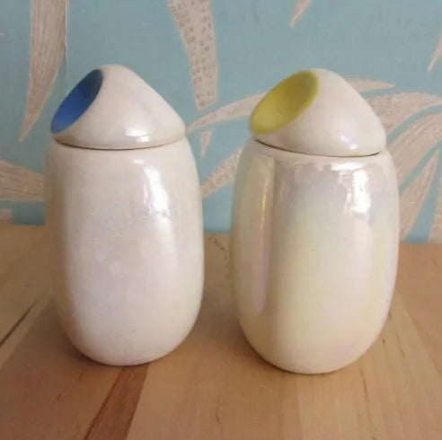 Three mid-century Romanian lustred ceramic storage caddies with contrast colour 'pinched' lids
