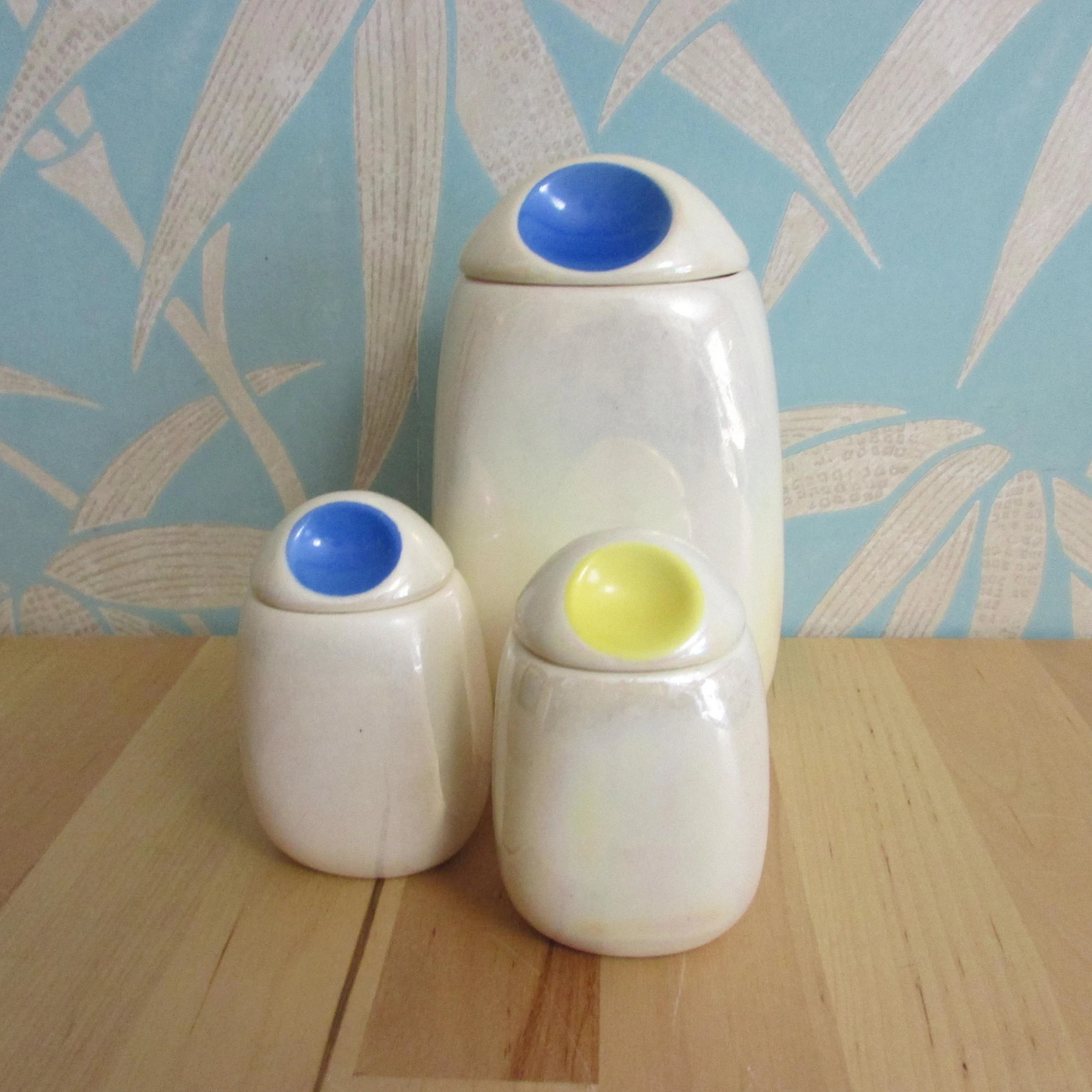 Three mid-century Romanian lustred ceramic storage caddies with contrast colour 'pinched' lids