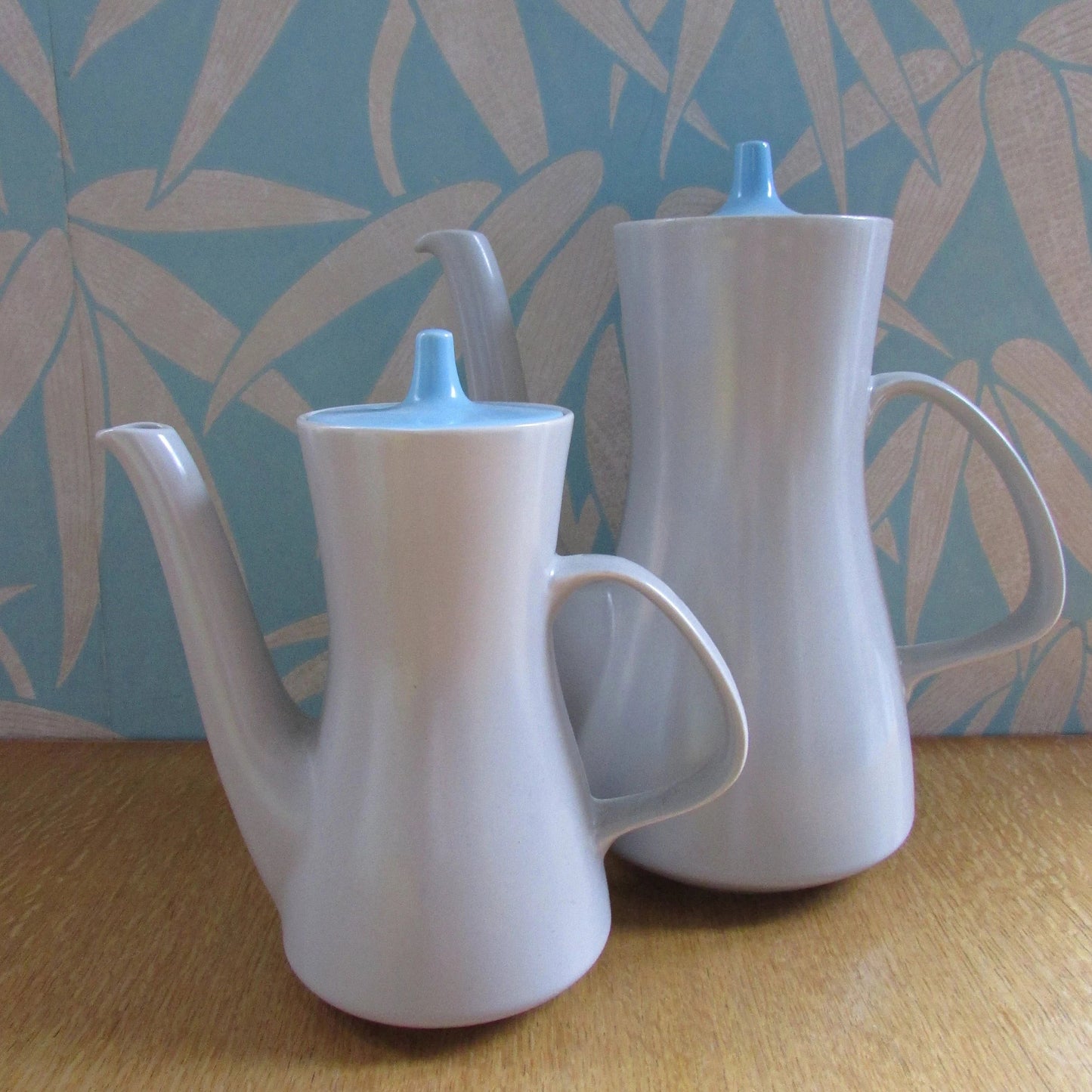 Pair of mid-century Poole Pottery ceramic Twintone contour coffee pots, Sky Blue & Dove Grey