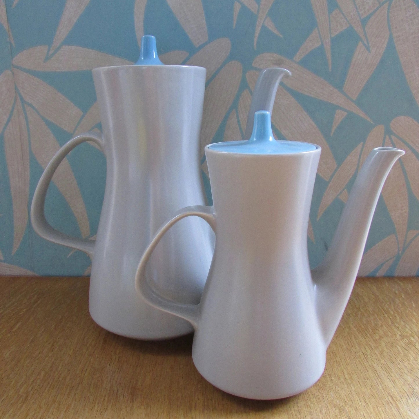 Pair of mid-century Poole Pottery ceramic Twintone contour coffee pots, Sky Blue & Dove Grey