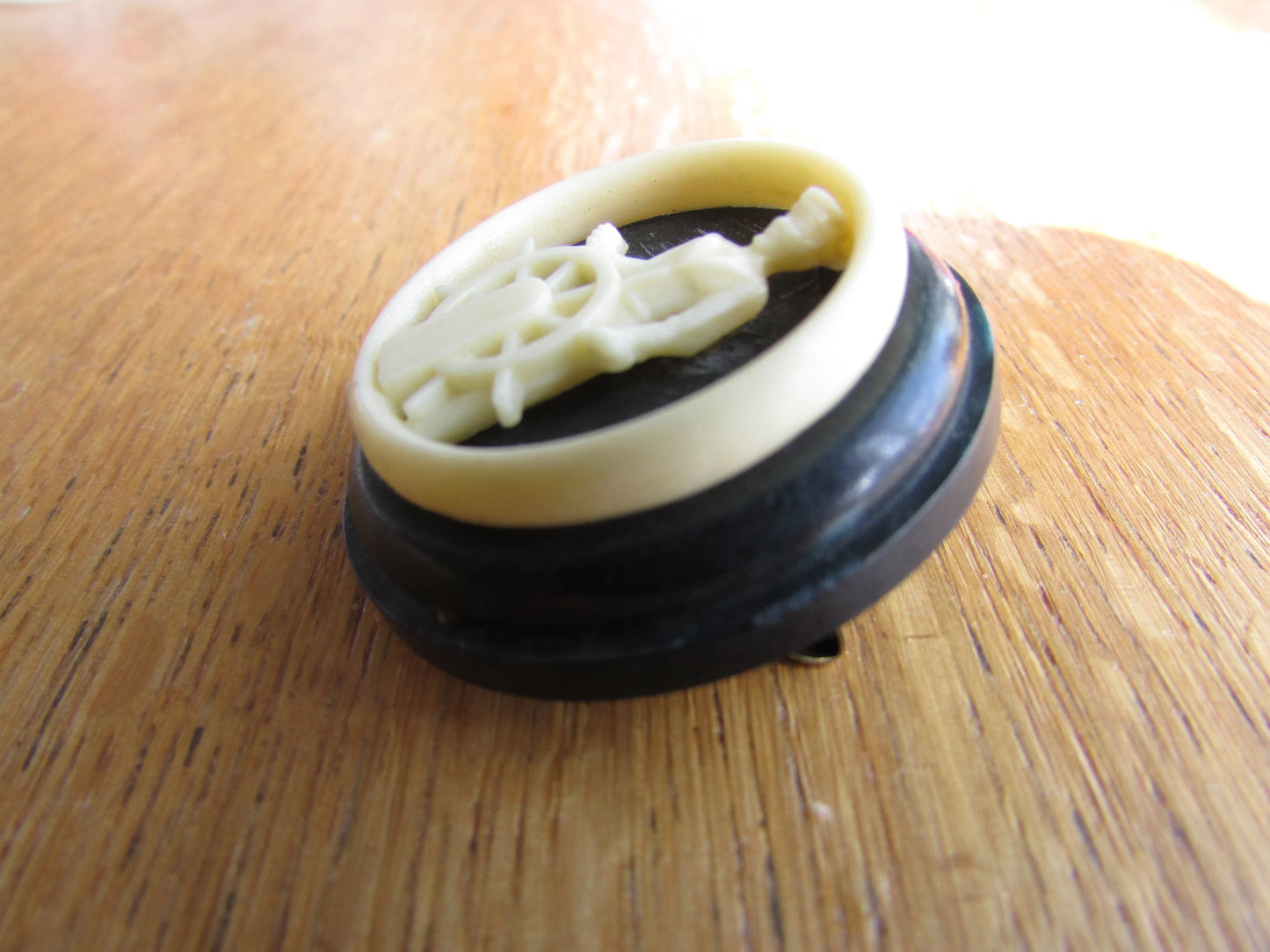 Home-made brooch using vintage plastic cocktail stirrer and vintage button