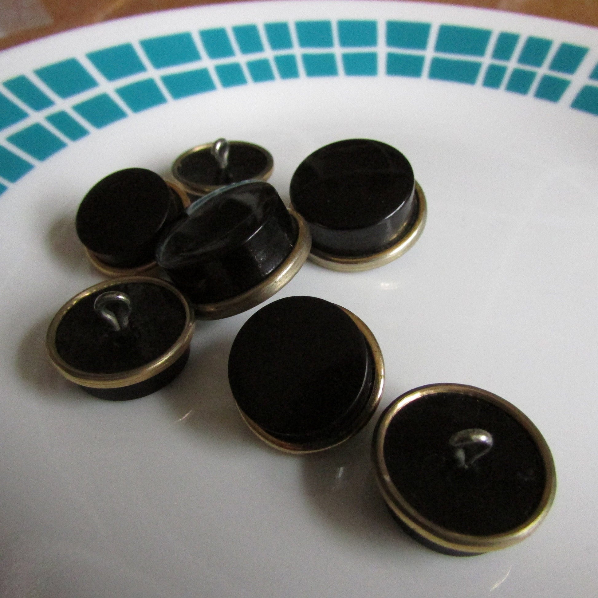 7 vintage black with gold-tone rim round plastic buttons