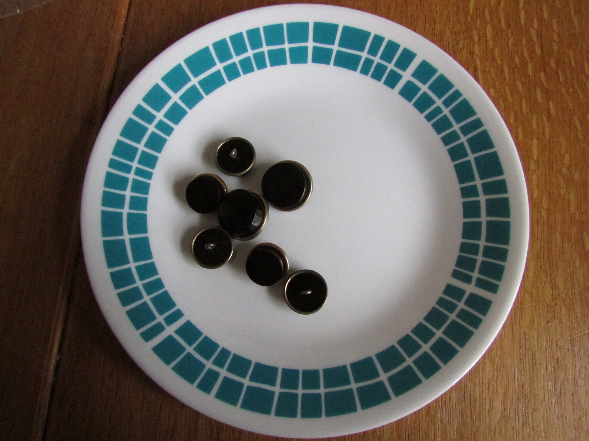 7 vintage black with gold-tone rim round plastic buttons