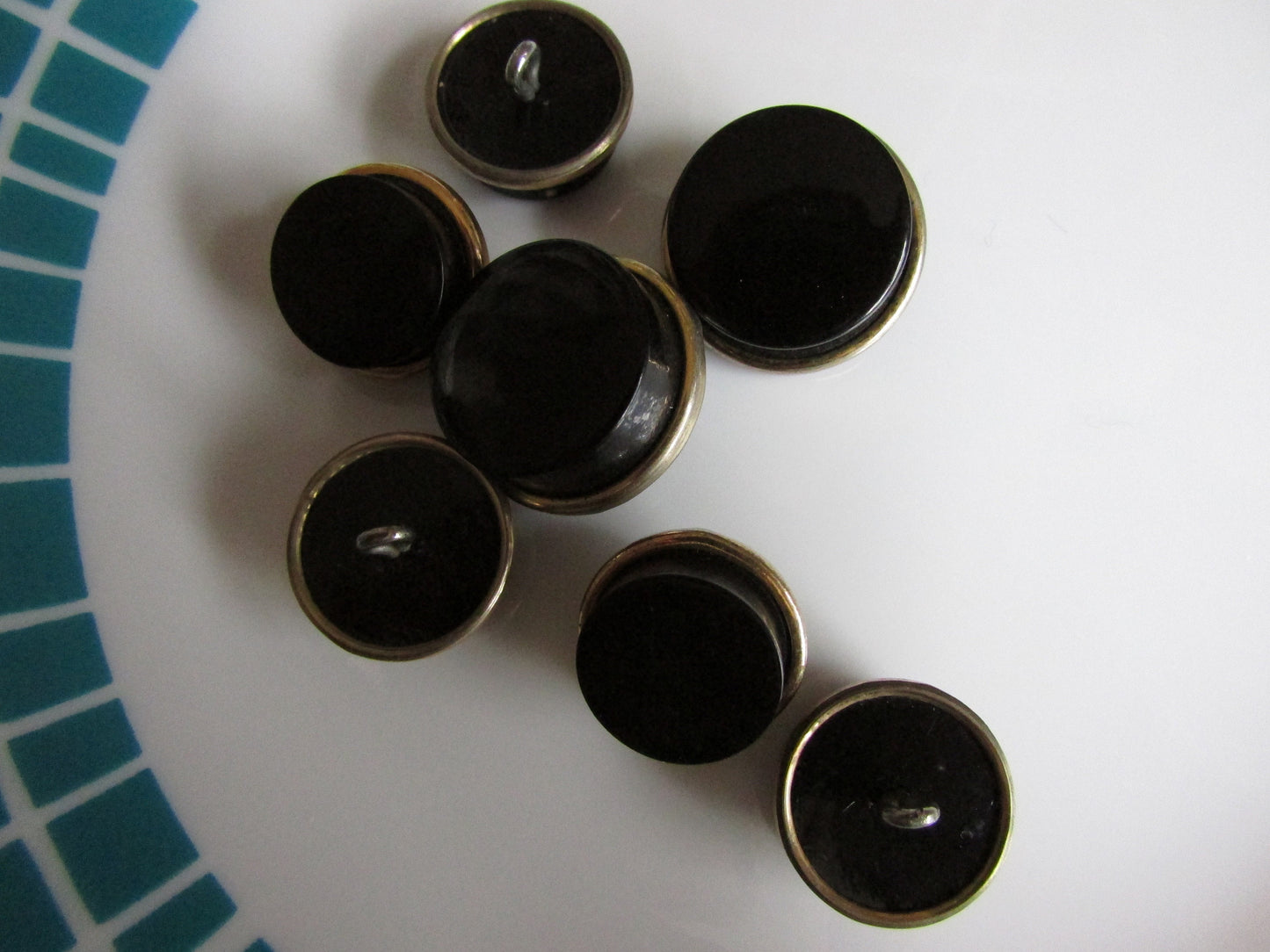 7 vintage black with gold-tone rim round plastic buttons