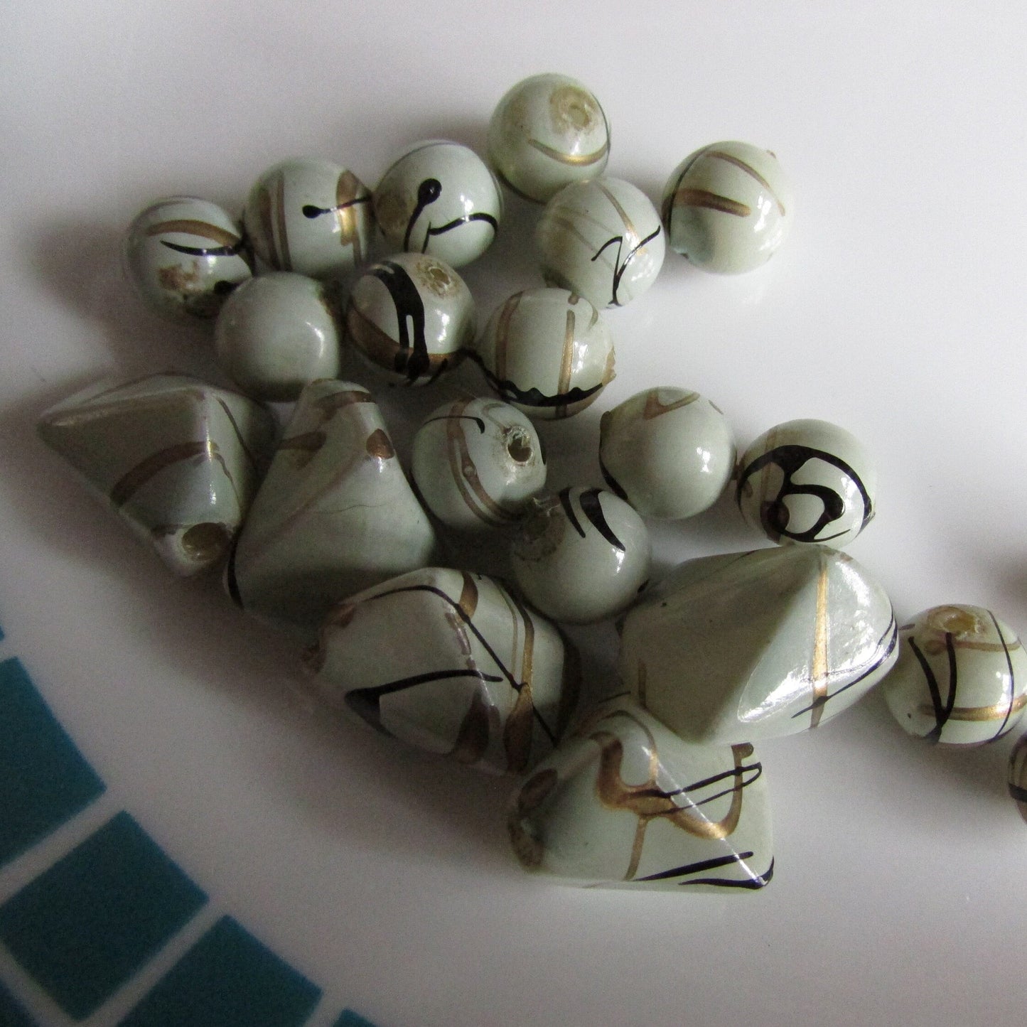 21 vintage pale grey with gold and black squiggles plastic beads