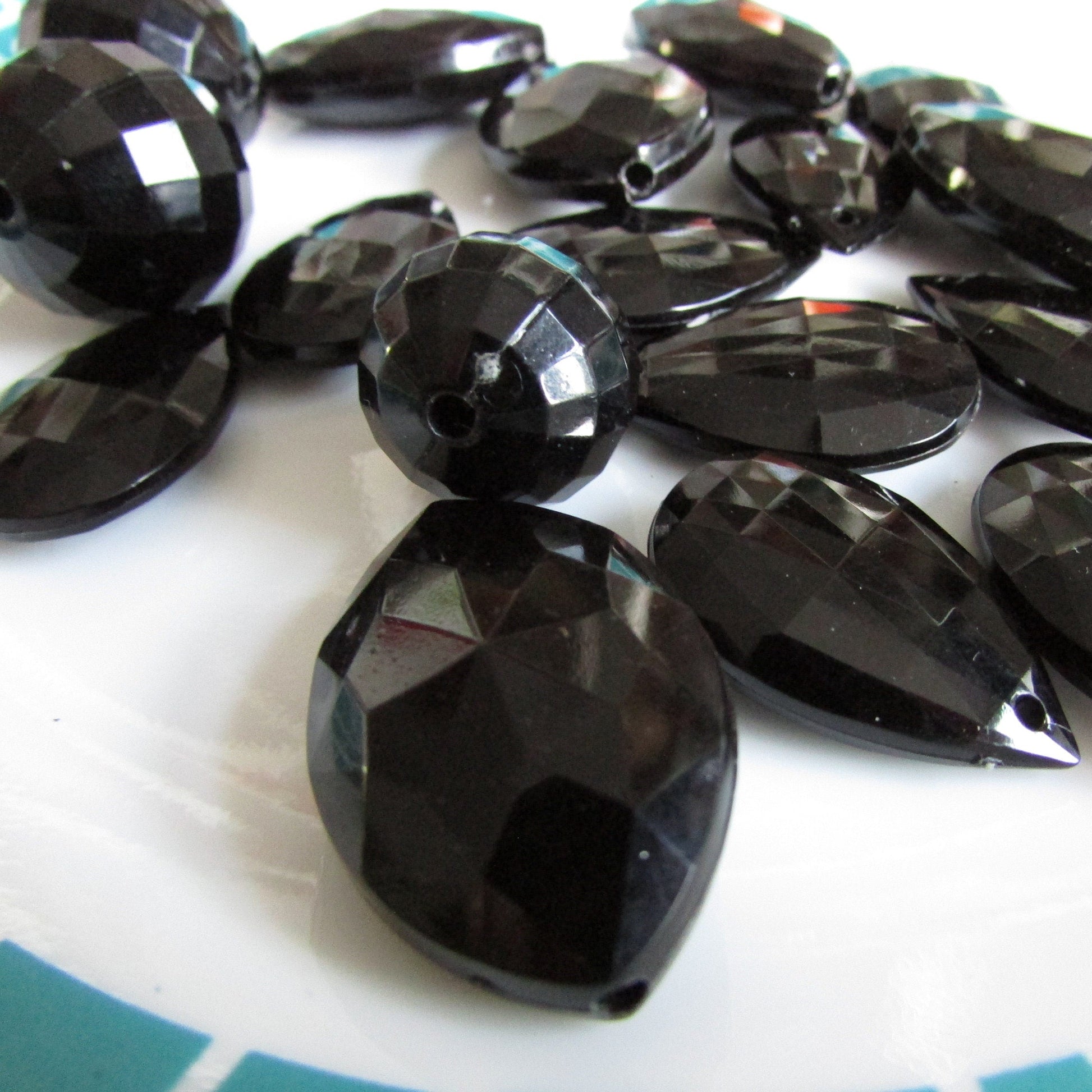 17 vintage black faceted teardrop, elliptical and globe plastic beads
