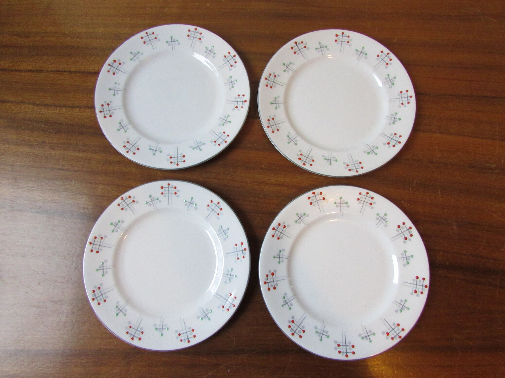 Four 1950s Vivace Roslyn hu-Era bone china side plates