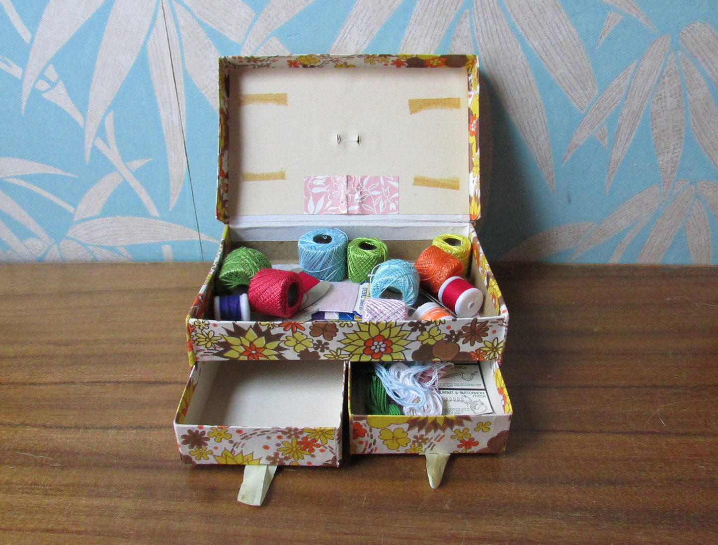 1960s floral patterned 2-drawer cardboard sewing box, with assorted vintage notions