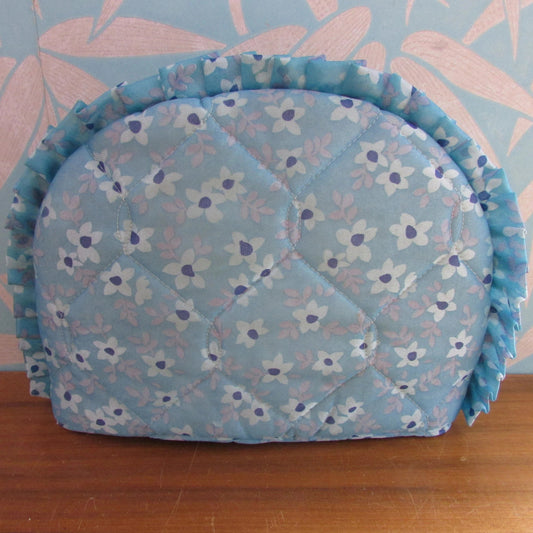 Vintage quilted blue floral tea cosy with ruffle edging