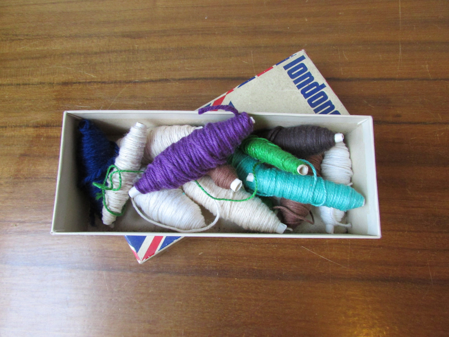 Vintage cardboard Londoner pipe box filled with assorted embroidery threads