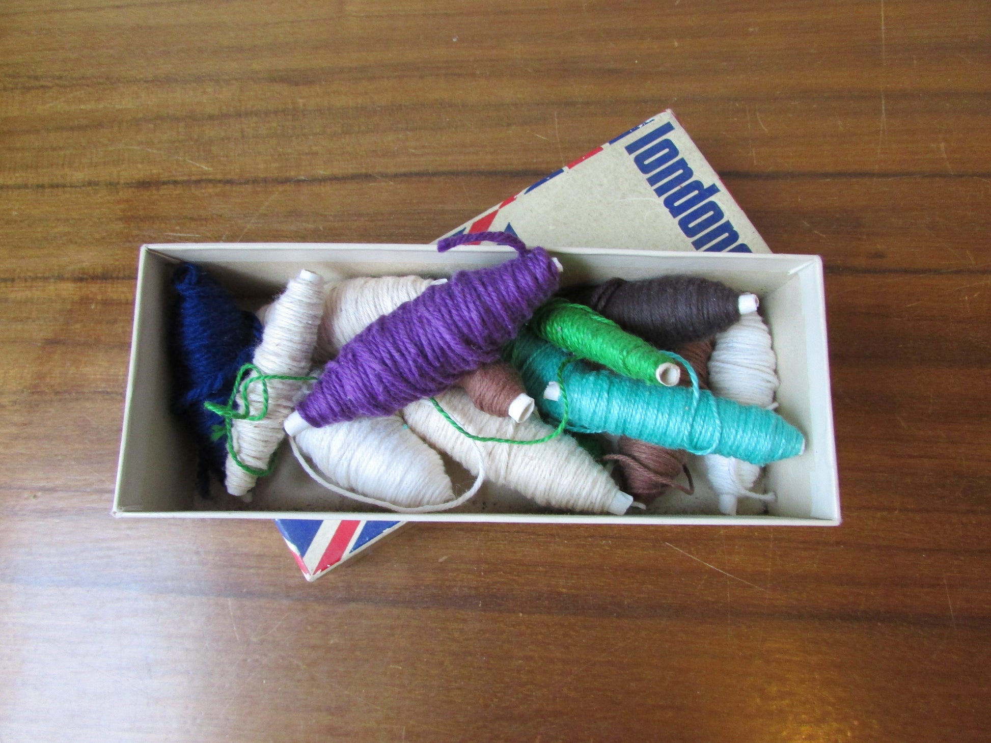 Vintage cardboard Londoner pipe box filled with assorted embroidery threads