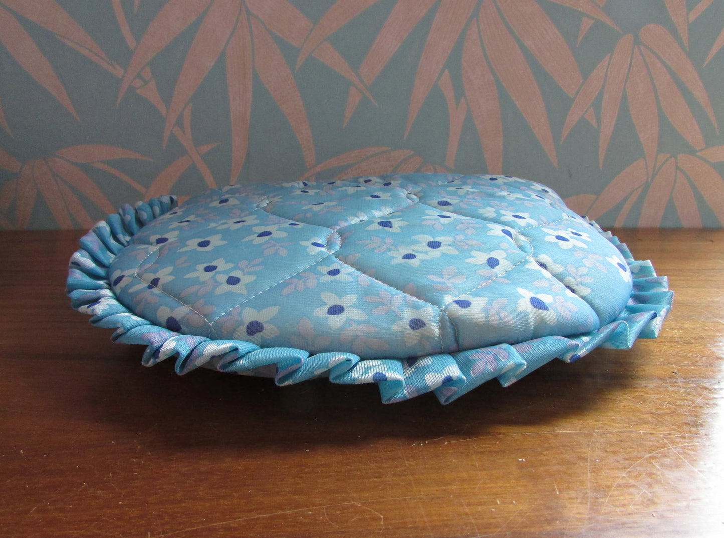 Vintage quilted blue floral tea cosy with ruffle edging