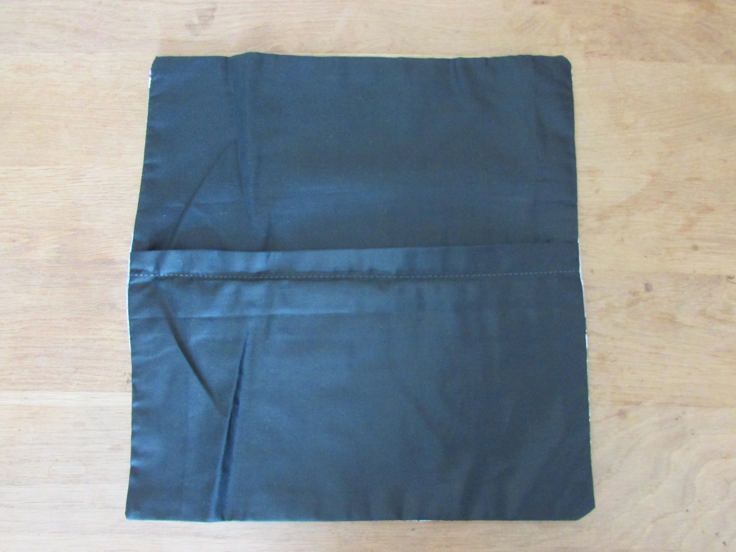 Home-made John Lewis 1950s-style haute couture pattern cushion cover with contrast black reverse