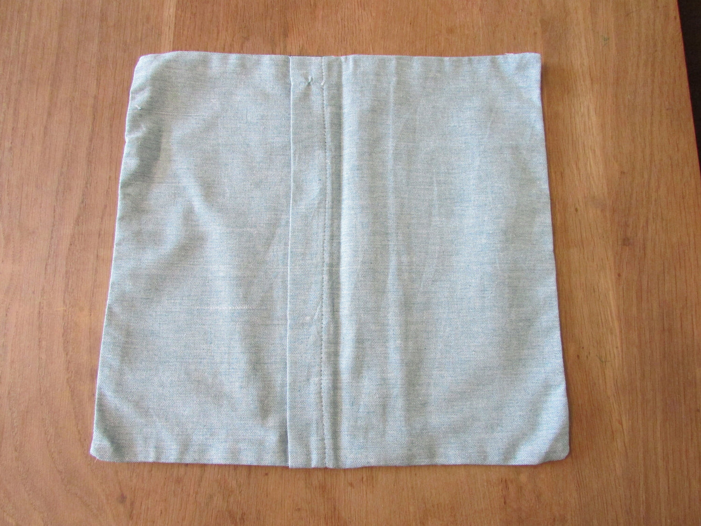 Home-made retro bright tropical print cushion cover with contrast eau de nil reverse