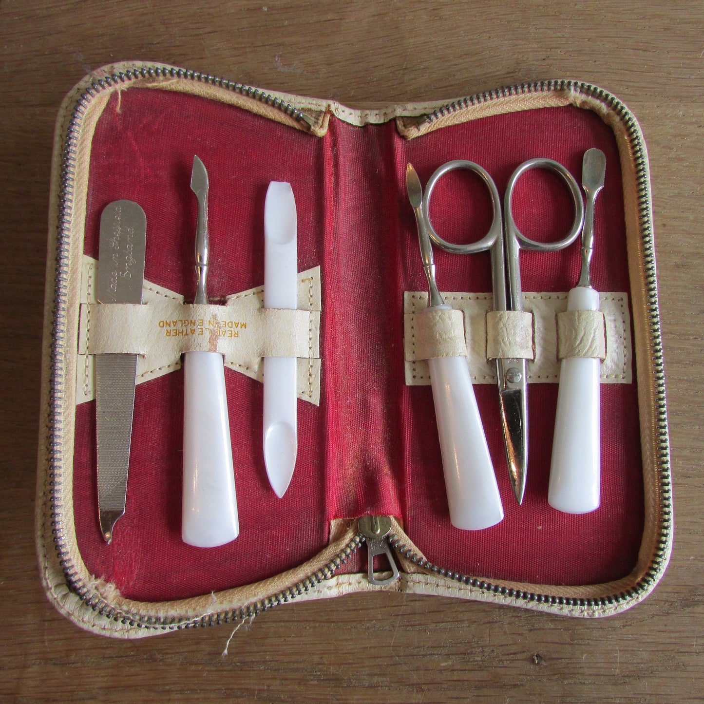 1950s manicure set in zipped leather travel case with red & gold flower detail