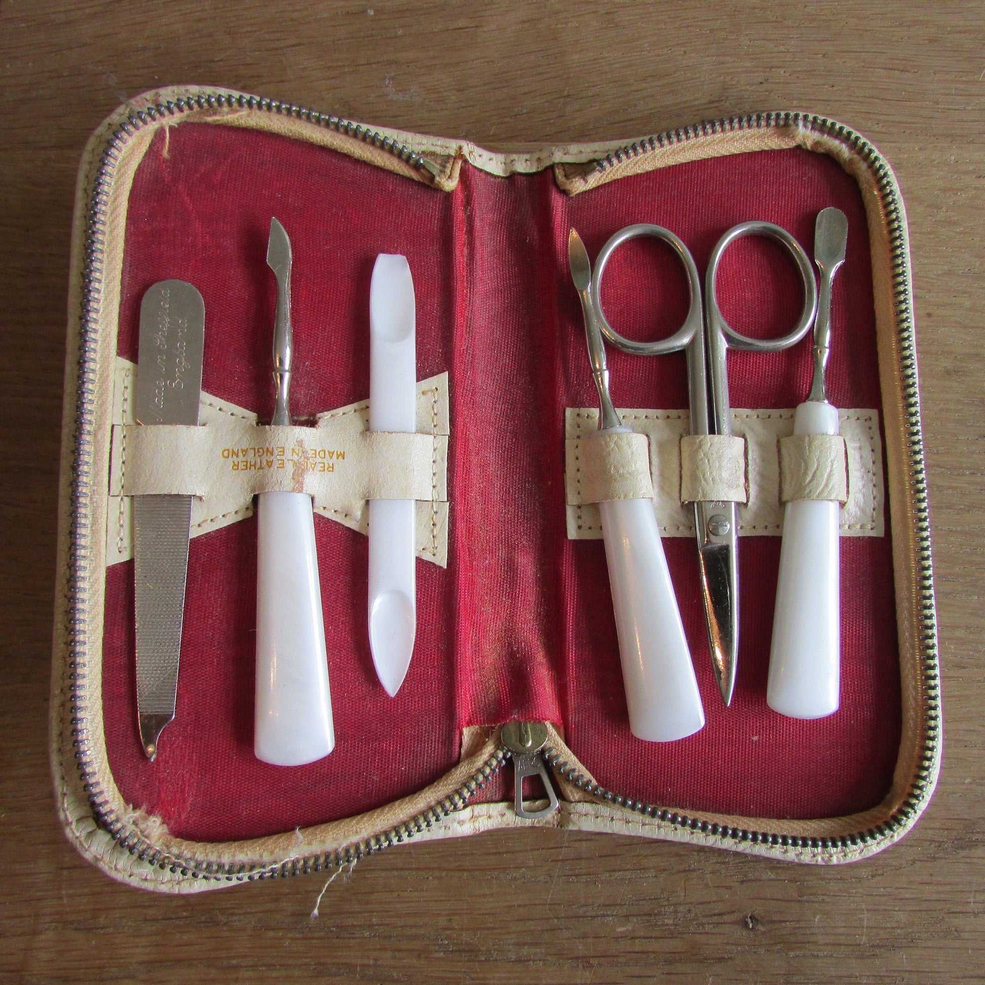 1950s manicure set in zipped leather travel case with red & gold flower detail