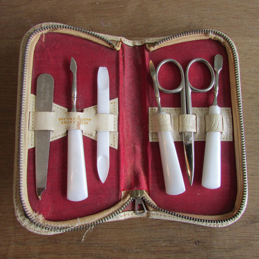 1950s manicure set in zipped leather travel case with red & gold flower detail