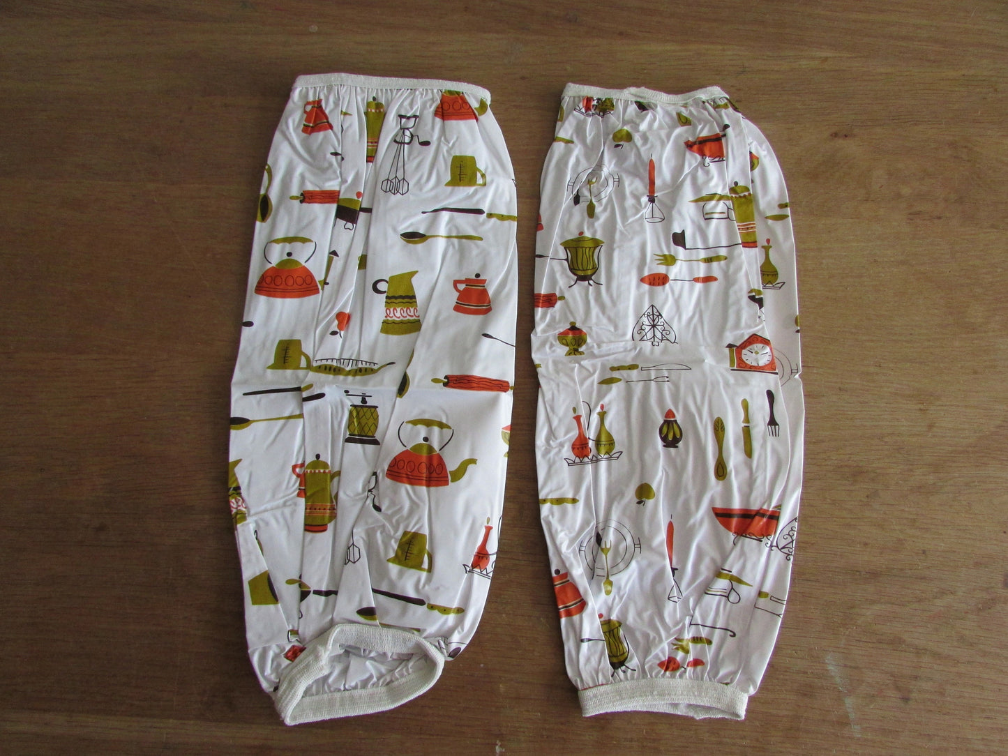 Pair of vintage Lakeland Plastics plastic sleeve protectors, 1950s style kitchen appliances/utensil print