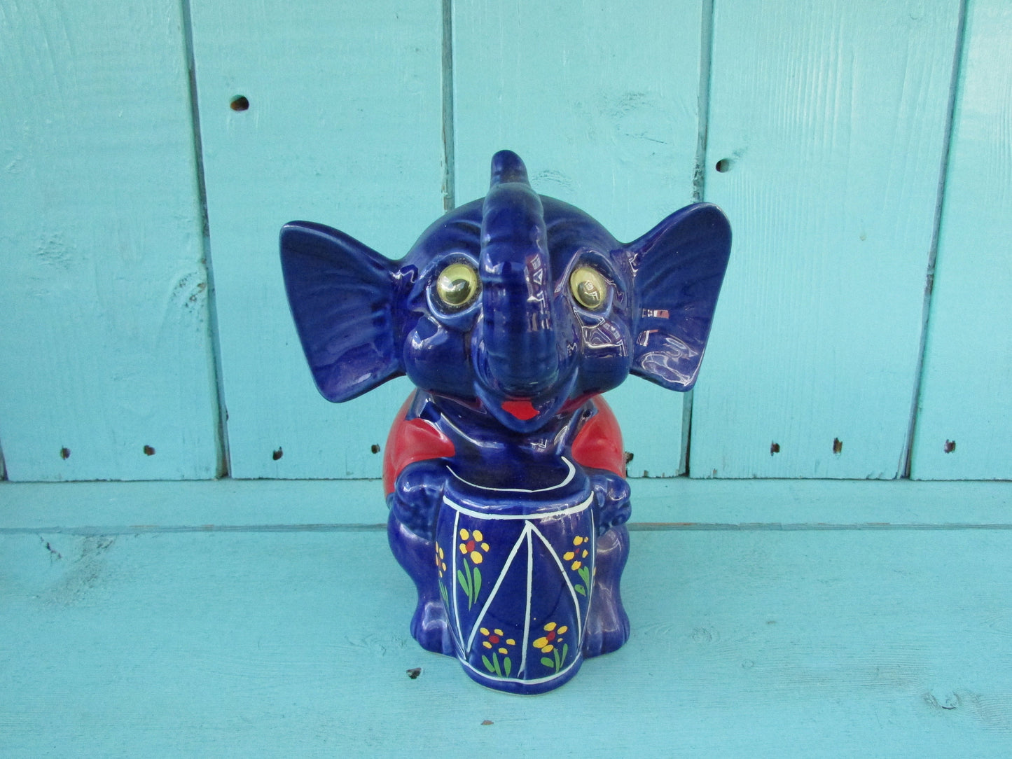 Vintage hand-painted blue ceramic elephant, with drum & googly eyes, money box