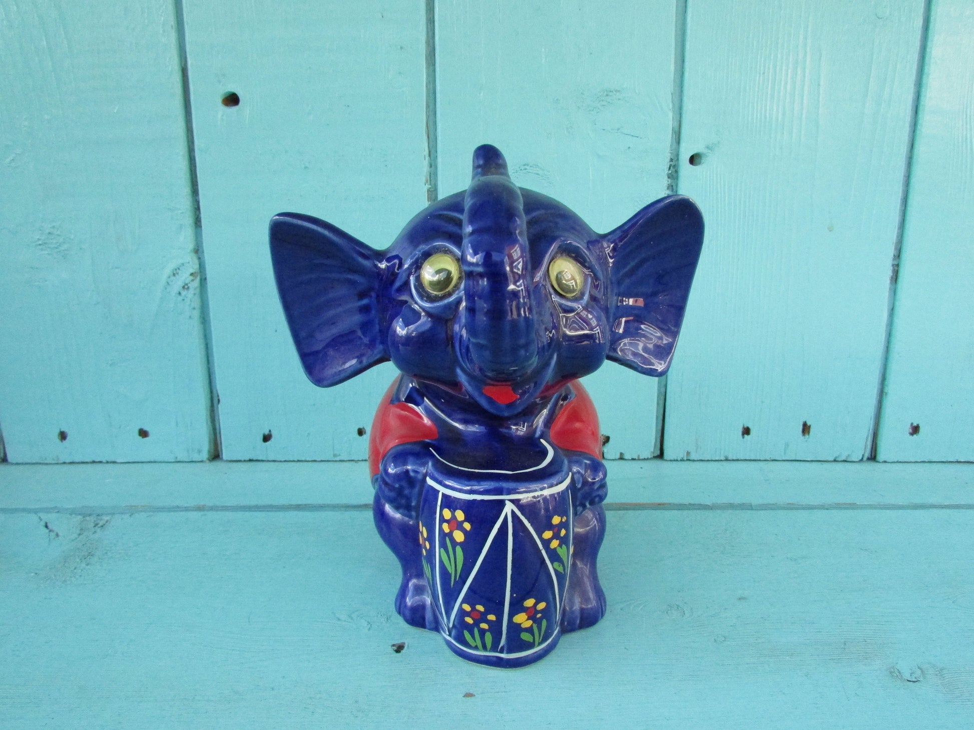 Vintage hand-painted blue ceramic elephant, with drum & googly eyes, money box