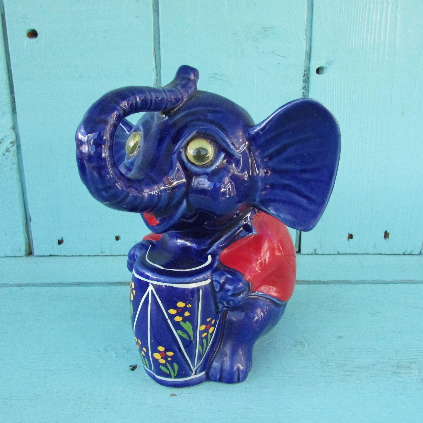 Vintage hand-painted blue ceramic elephant, with drum & googly eyes, money box