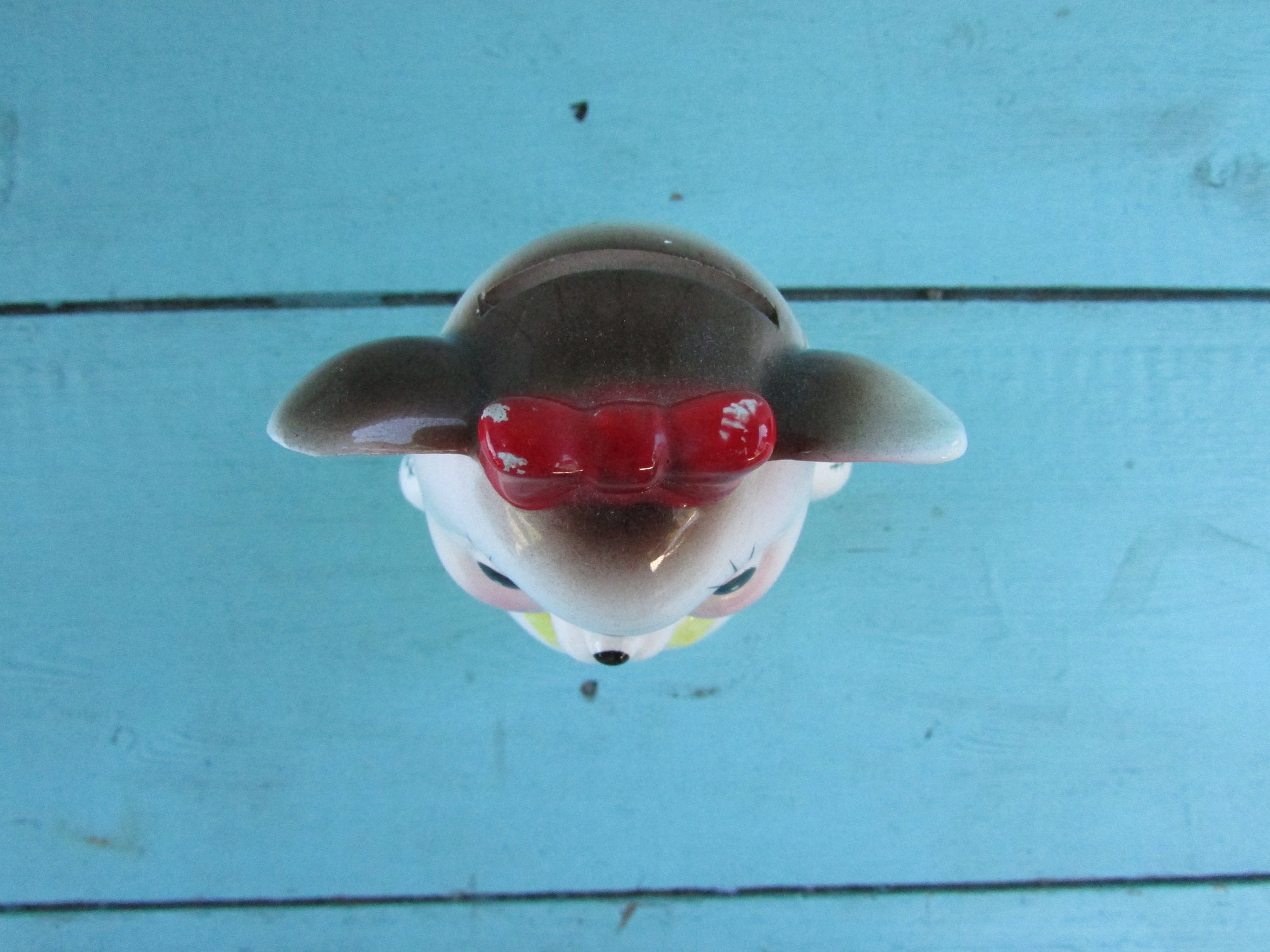 Vintage ceramic dog money box, with red hair bow detail, marked Foreign