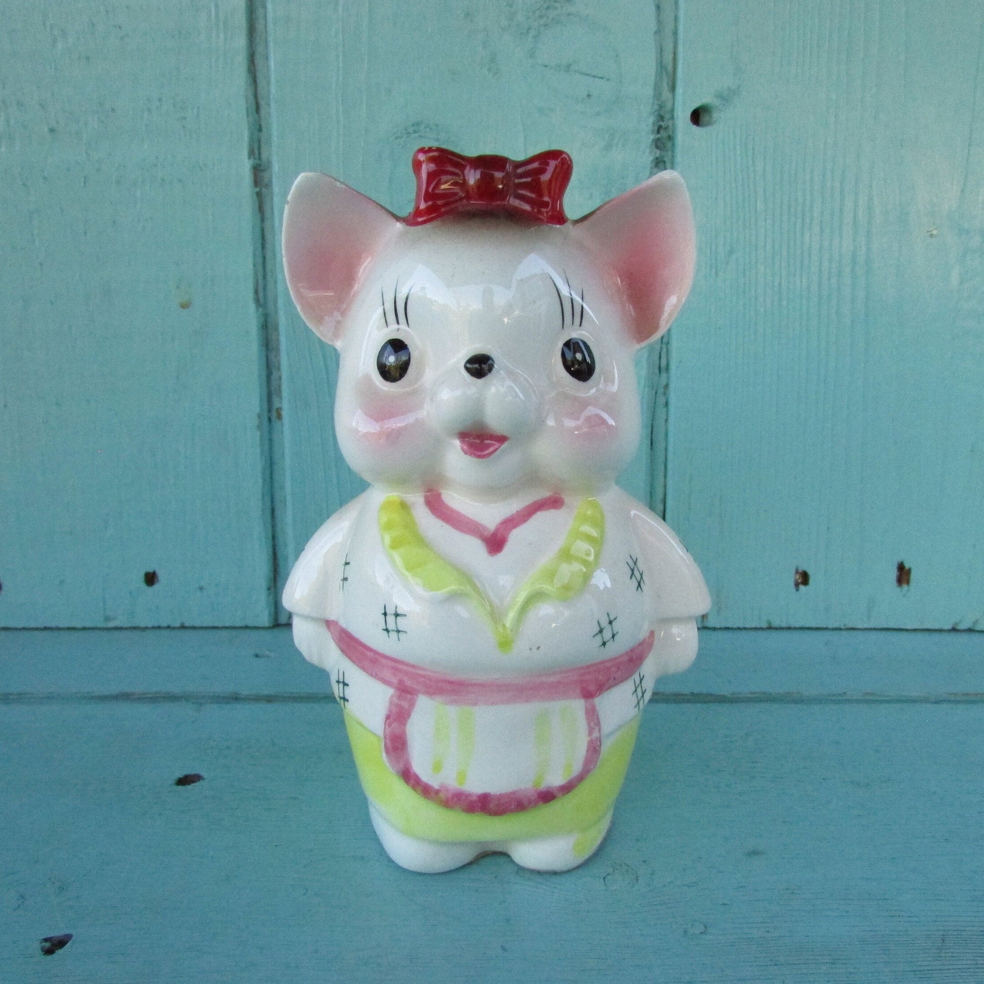 Vintage ceramic dog money box, with red hair bow detail, marked Foreign
